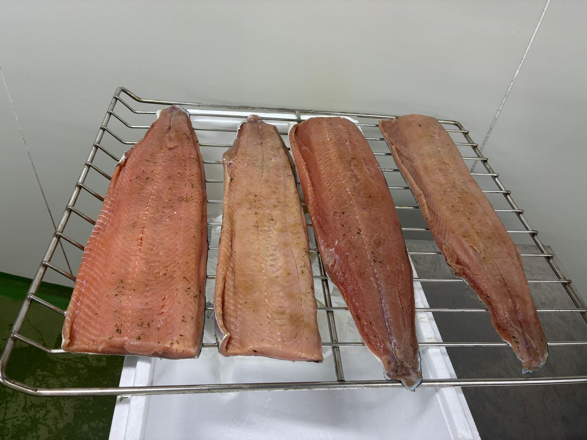 These images capture the full journey of wild keta salmon line‑caught from British Columbia and cold‑smoked naturally in Singapore by DishTheFish. From whole fresh salmon to fillets cured with dill, salt, and brown sugar, then smoked in commercial Alto‑Shaam ovens, each stage is shown clearly for accessibility. The alt text highlights Singapore as the processing location and emphasizes keywords like wild keta salmon, cold smoked, fresh dill, and DishTheFish Singapore, ensuring the visuals